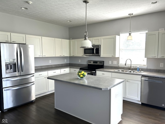 8287 Falkirk Dr, Avon, IN 46123 - kitchen featuring appliances with stainless steel finishes, dark wood-type flooring, a textured ceiling, white cabinets, and hanging light fixtures