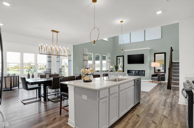 17040 Daly Dr, Noblesville, IN 46062 - kitchen featuring stainless steel dishwasher, open floor plan, wood finished floors, recessed lighting, and an island with sink