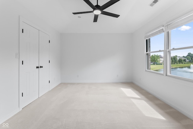 9877 Wading Crane Ave, Fishers, IN 46055 - unfurnished bedroom with light colored carpet, a closet, ceiling fan, and vaulted ceiling