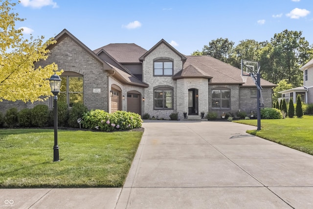9877 Wading Crane Ave, Fishers, IN 46055 - french country style house with driveway, a front yard, brick siding, and stone siding