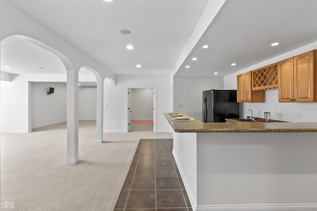 9877 Wading Crane Ave, Fishers, IN 46055 - kitchen with freestanding refrigerator, recessed lighting, dark countertops, carpet, and open floor plan