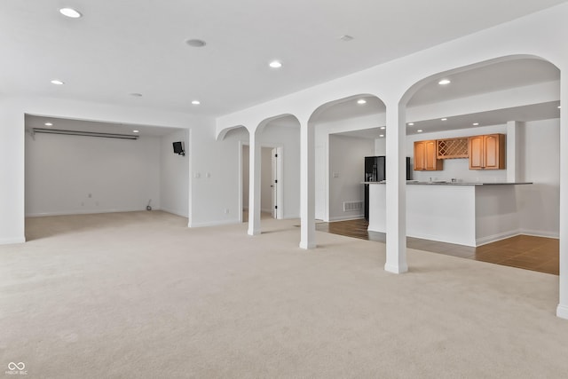 9877 Wading Crane Ave, Fishers, IN 46055 - unfurnished living room featuring light carpet, recessed lighting, and bar with sink