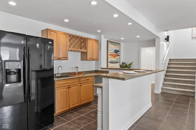 9877 Wading Crane Ave, Fishers, IN 46055 - kitchen featuring black refrigerator with ice dispenser, recessed lighting, dark tile patterned floors, and dark stone countertops