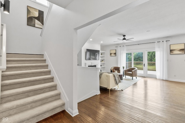 9877 Wading Crane Ave, Fishers, IN 46055 - living room featuring a ceiling fan, wood finished floors, stairway, a fireplace, and recessed lighting