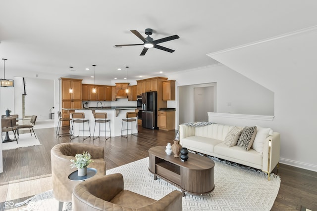 9877 Wading Crane Ave, Fishers, IN 46055 - living area with ceiling fan, recessed lighting, dark wood-style floors, and ornamental molding
