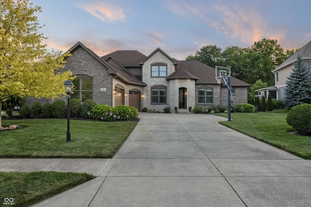 9877 Wading Crane Ave, Fishers, IN 46055 - french provincial home featuring concrete driveway, a lawn, brick siding, a shingled roof, and stone siding