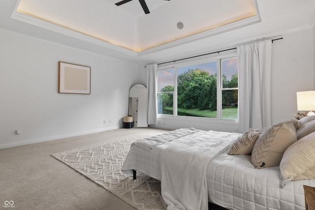 9877 Wading Crane Ave, Fishers, IN 46055 - bedroom featuring a tray ceiling, light colored carpet, crown molding, and a ceiling fan