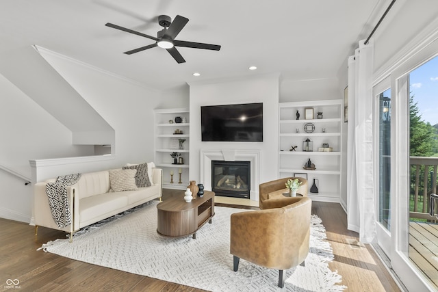 9877 Wading Crane Ave, Fishers, IN 46055 - living room featuring a ceiling fan, wood finished floors, a fireplace with flush hearth, crown molding, and recessed lighting