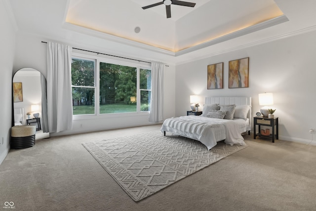 9877 Wading Crane Ave, Fishers, IN 46055 - carpeted bedroom featuring a tray ceiling, arched walkways, and a ceiling fan