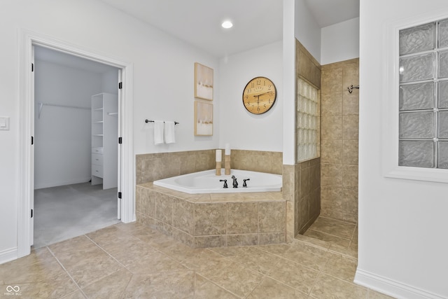 9877 Wading Crane Ave, Fishers, IN 46055 - bathroom featuring a bath, tile patterned floors, tiled shower, and a spacious closet