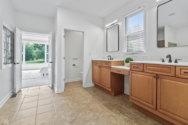 9877 Wading Crane Ave, Fishers, IN 46055 - bathroom featuring vanity, plenty of natural light, tile patterned floors, and ensuite bathroom