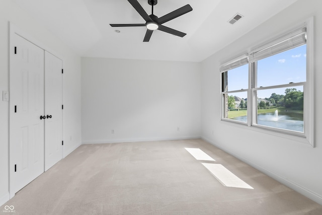 9877 Wading Crane Ave, Fishers, IN 46055 - unfurnished bedroom featuring light colored carpet, vaulted ceiling, a closet, and a ceiling fan