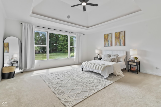 9877 Wading Crane Ave, Fishers, IN 46055 - carpeted bedroom with a tray ceiling, arched walkways, and a ceiling fan