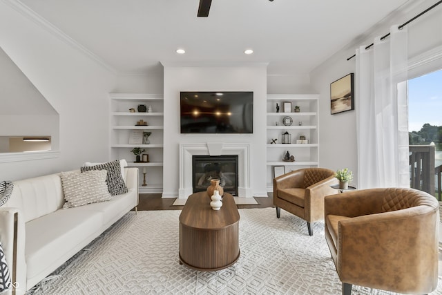9877 Wading Crane Ave, Fishers, IN 46055 - living room with wood finished floors, a fireplace with flush hearth, built in shelves, ceiling fan, and recessed lighting