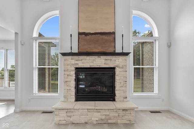 9877 Wading Crane Ave, Fishers, IN 46055 - unfurnished living room with carpet floors, plenty of natural light, and a fireplace