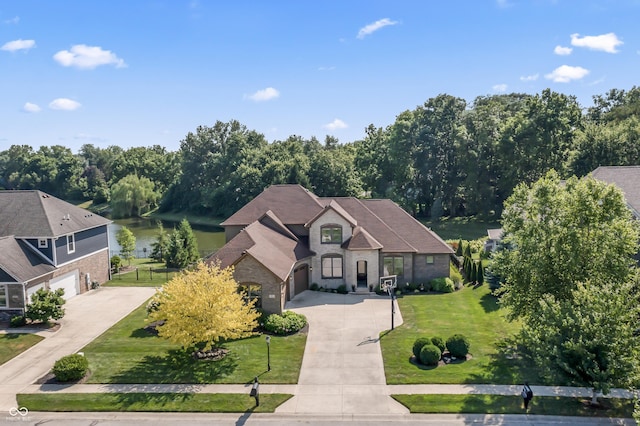 9877 Wading Crane Ave, Fishers, IN 46055 - french country home with driveway, a water view, stone siding, a front yard, and an attached garage