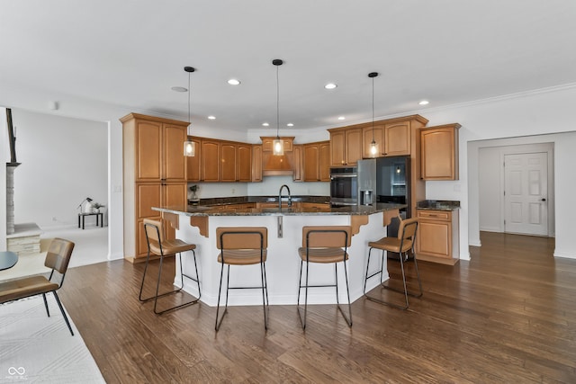 9877 Wading Crane Ave, Fishers, IN 46055 - kitchen featuring stainless steel appliances, recessed lighting, a center island with sink, dark wood-style floors, and a kitchen breakfast bar