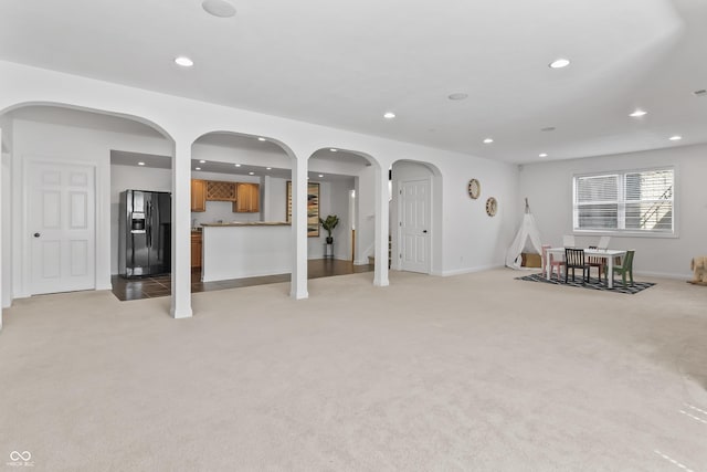 9877 Wading Crane Ave, Fishers, IN 46055 - living area featuring light colored carpet, recessed lighting, and arched walkways