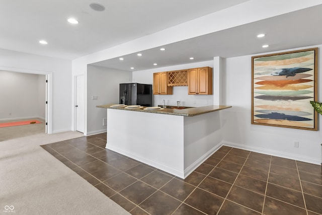9877 Wading Crane Ave, Fishers, IN 46055 - kitchen with black refrigerator with ice dispenser, recessed lighting, a peninsula, and dark countertops