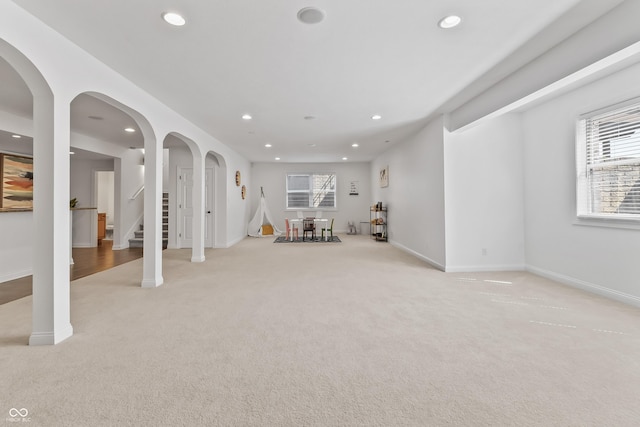 9877 Wading Crane Ave, Fishers, IN 46055 - basement featuring light carpet, recessed lighting, stairway, and arched walkways