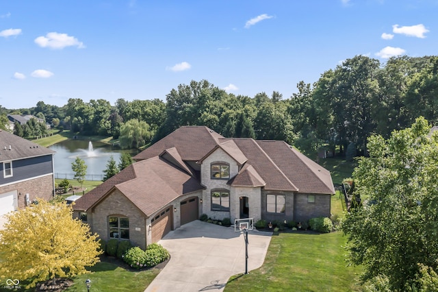 9877 Wading Crane Ave, Fishers, IN 46055 - french country inspired facade featuring a garage, brick siding, a water view, concrete driveway, and a front yard