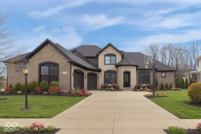 9877 Wading Crane Ave, Fishers, IN 46055 - french country inspired facade featuring driveway, brick siding, a front lawn, and an attached garage