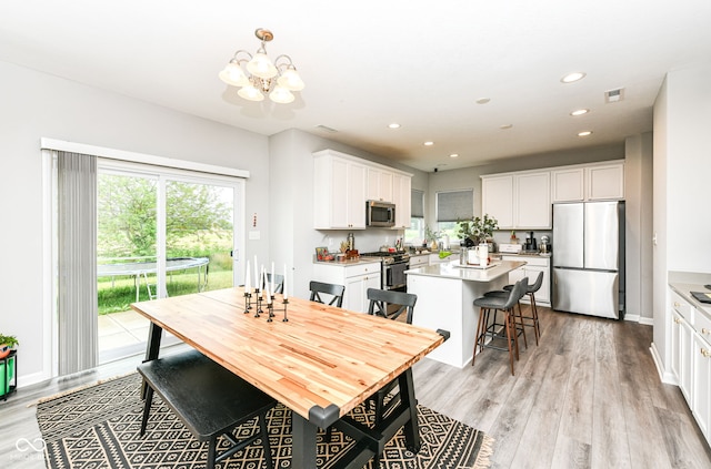 4309 Maize Ln, Whitestown, IN 46075 - dining space featuring a chandelier, light wood-style flooring, and recessed lighting