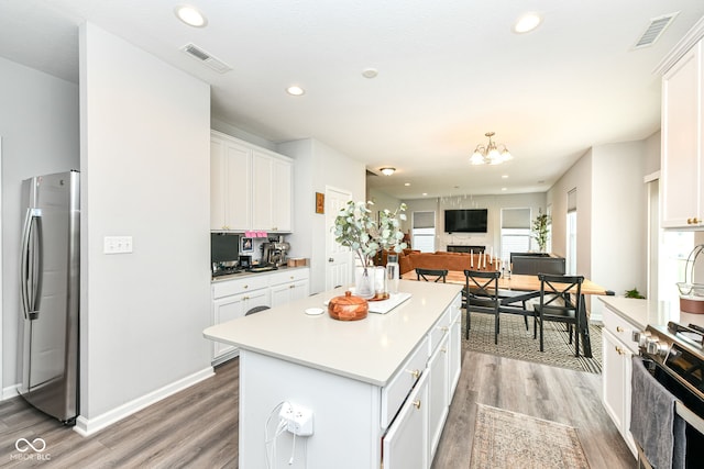 4309 Maize Ln, Whitestown, IN 46075 - kitchen featuring appliances with stainless steel finishes, light wood-type flooring, white cabinets, and recessed lighting