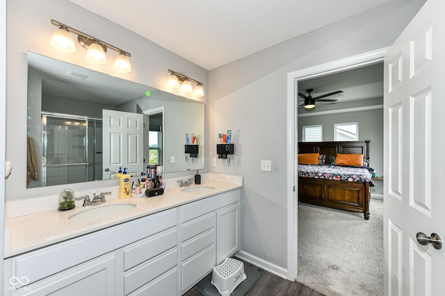 4309 Maize Ln, Whitestown, IN 46075 - full bathroom featuring a shower stall, double vanity, a ceiling fan, connected bathroom, and wood finished floors