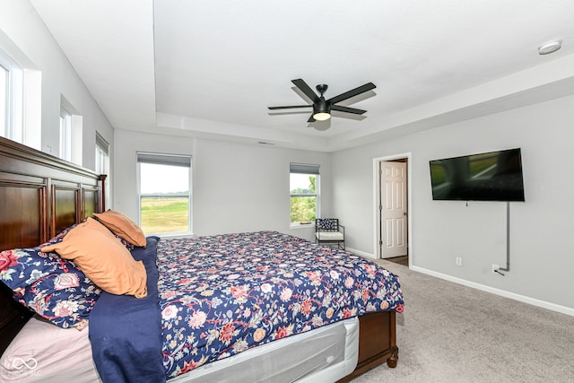 4309 Maize Ln, Whitestown, IN 46075 - carpeted bedroom with a tray ceiling and ceiling fan