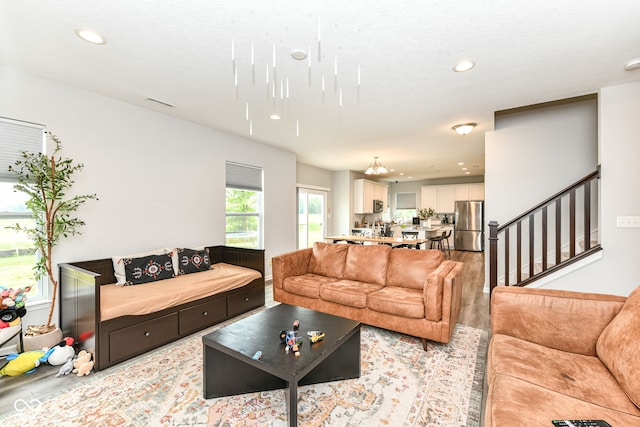 4309 Maize Ln, Whitestown, IN 46075 - living area featuring light wood-type flooring, recessed lighting, a chandelier, and stairway