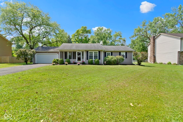 4143 E 61st St, Indianapolis, IN 46220 - ranch-style home with asphalt driveway and an attached garage