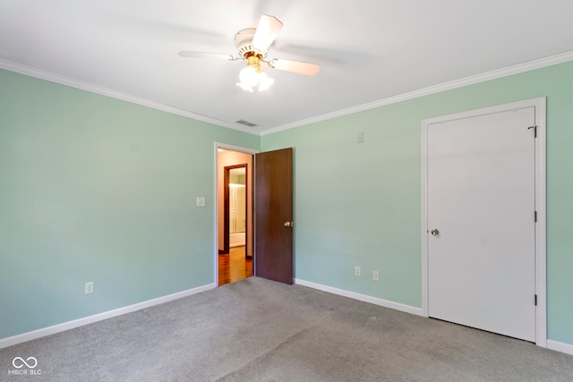 4143 E 61st St, Indianapolis, IN 46220 - unfurnished bedroom featuring carpet floors, crown molding, and a ceiling fan