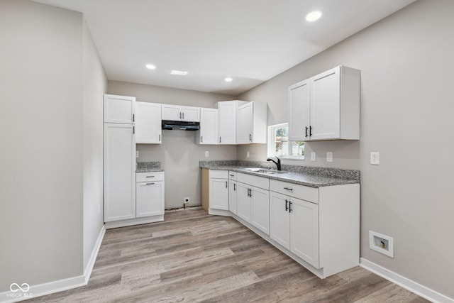 902 Woodrow Ave, Indianapolis, IN 46241 - kitchen featuring under cabinet range hood, white cabinets, light wood-type flooring, and recessed lighting