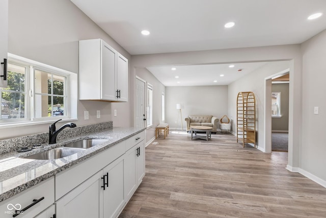 902 Woodrow Ave, Indianapolis, IN 46241 - kitchen featuring light wood-style flooring, white cabinets, recessed lighting, light stone counters, and open floor plan
