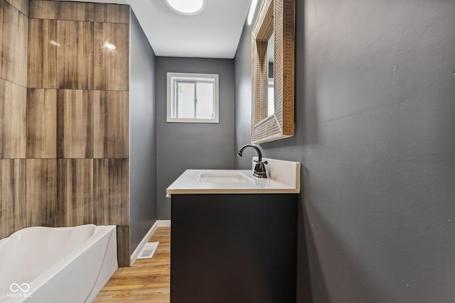 902 Woodrow Ave, Indianapolis, IN 46241 - bathroom featuring vanity, a tub, and wood finished floors