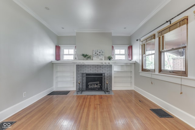 1005 Main St, Beech Grove, IN 46107 - unfurnished living room with wood-type flooring, a brick fireplace, plenty of natural light, and crown molding