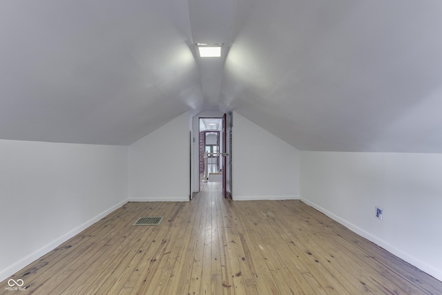 1005 Main St, Beech Grove, IN 46107 - additional living space featuring vaulted ceiling and light wood-style flooring