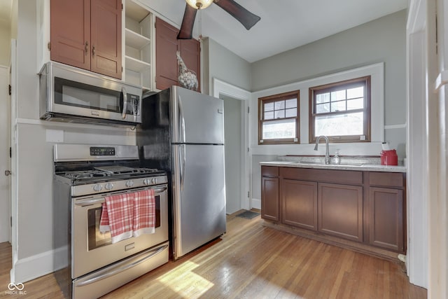 1005 Main St, Beech Grove, IN 46107 - kitchen featuring appliances with stainless steel finishes, ceiling fan, open shelves, and light wood-type flooring