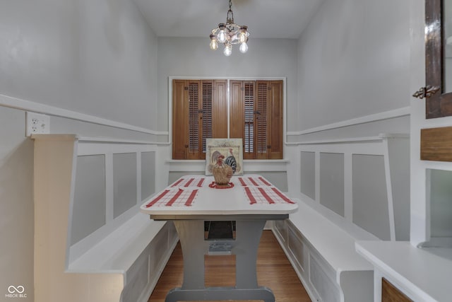 1005 Main St, Beech Grove, IN 46107 - dining area featuring a decorative wall, wainscoting, wood finished floors, breakfast area, and a chandelier