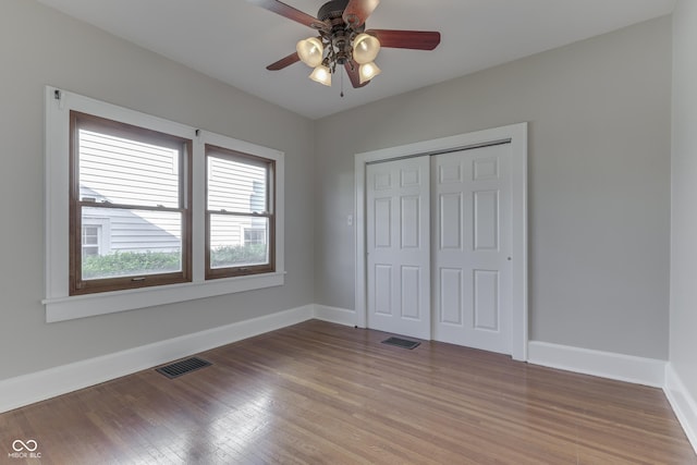 1005 Main St, Beech Grove, IN 46107 - unfurnished bedroom with light wood-style flooring, a closet, and a ceiling fan