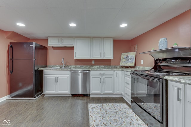 1005 Main St, Beech Grove, IN 46107 - kitchen with black appliances, white cabinetry, wood finished floors, and recessed lighting