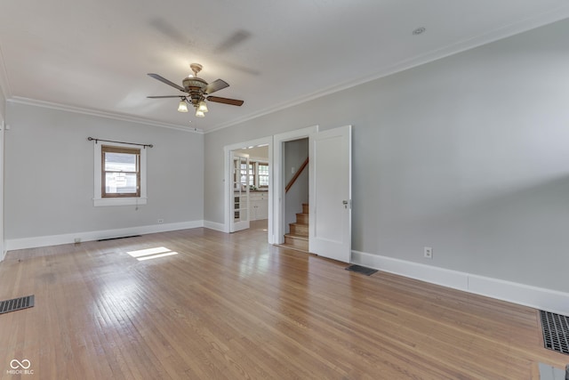 1005 Main St, Beech Grove, IN 46107 - unfurnished room featuring plenty of natural light, a ceiling fan, stairway, ornamental molding, and light wood-type flooring