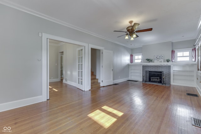1005 Main St, Beech Grove, IN 46107 - unfurnished living room with stairs, a ceiling fan, light wood-style flooring, a fireplace, and ornamental molding