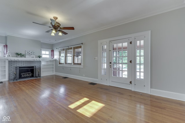 1005 Main St, Beech Grove, IN 46107 - unfurnished living room with a ceiling fan, crown molding, wood finished floors, and a brick fireplace