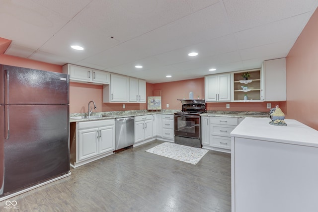 1005 Main St, Beech Grove, IN 46107 - kitchen with black appliances, wood finished floors, white cabinetry, open shelves, and recessed lighting