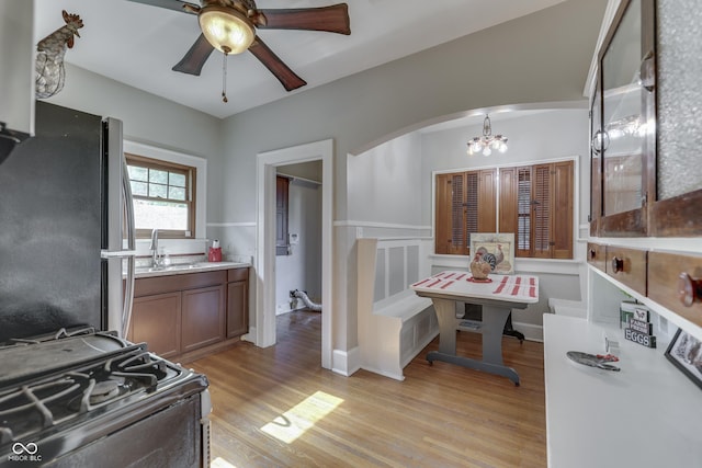 1005 Main St, Beech Grove, IN 46107 - kitchen featuring freestanding refrigerator, gas stove, a chandelier, light wood-type flooring, and ceiling fan