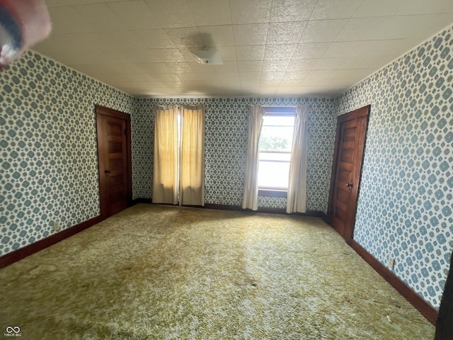 1652 High St, Fort Wayne, IN 46808 - spare room featuring wallpapered walls and carpet floors