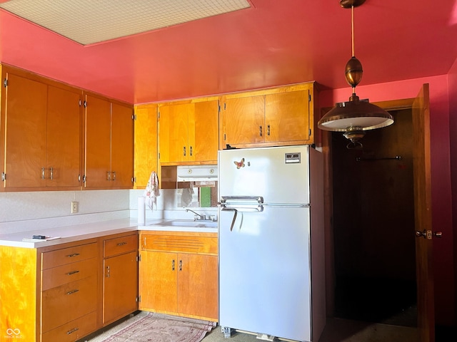 1652 High St, Fort Wayne, IN 46808 - kitchen with freestanding refrigerator, light countertops, and brown cabinets