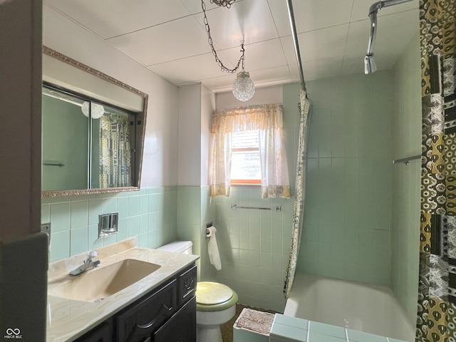 1652 High St, Fort Wayne, IN 46808 - bathroom featuring tile walls, vanity, tiled shower / bath, and a wainscoted wall